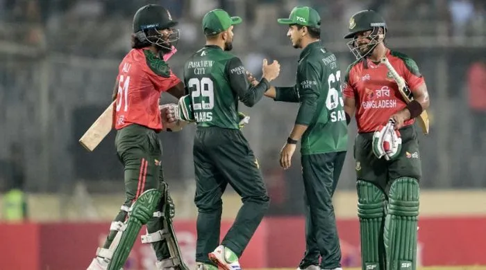 Pakistan vs Bangladesh players shake hands after a T20 cricket match.