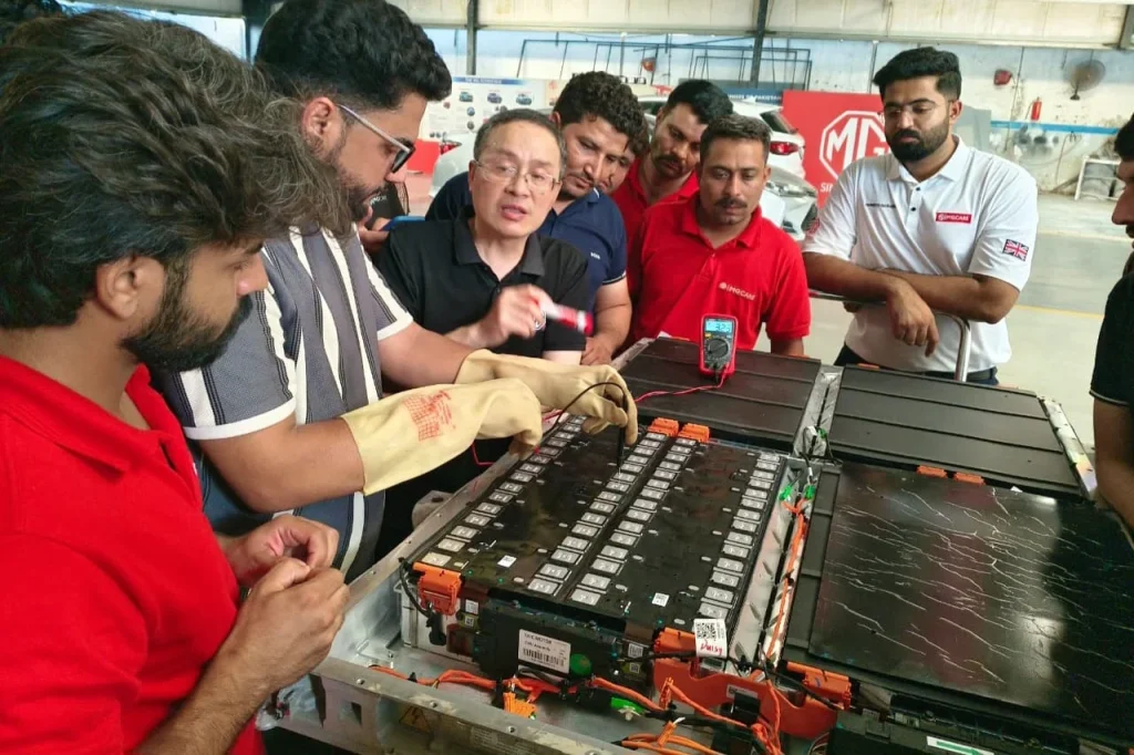 MG Motor Pakistan dealership technicians receiving hands-on hybrid vehicle battery training as part of nationwide after-sales readiness for MG HS Hybrid+ and MG HS Super Hybrid.