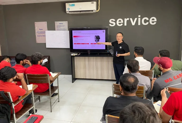 MG Motor Pakistan dealership technicians receiving hands-on hybrid vehicle battery training as part of nationwide after-sales readiness for MG HS Hybrid+ and MG HS Super Hybrid.