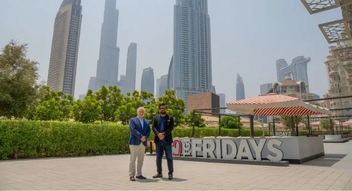 TGI Fridays representatives in front of a TGI Fridays location as the brand announces plans to expand across Pakistan through a development agreement with Meerab Hospitality.